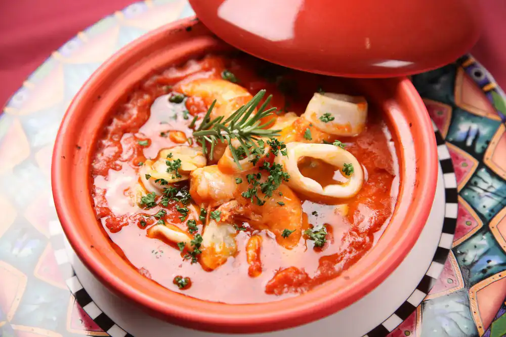 Aromatic shellfish broth in a ceramic bowl